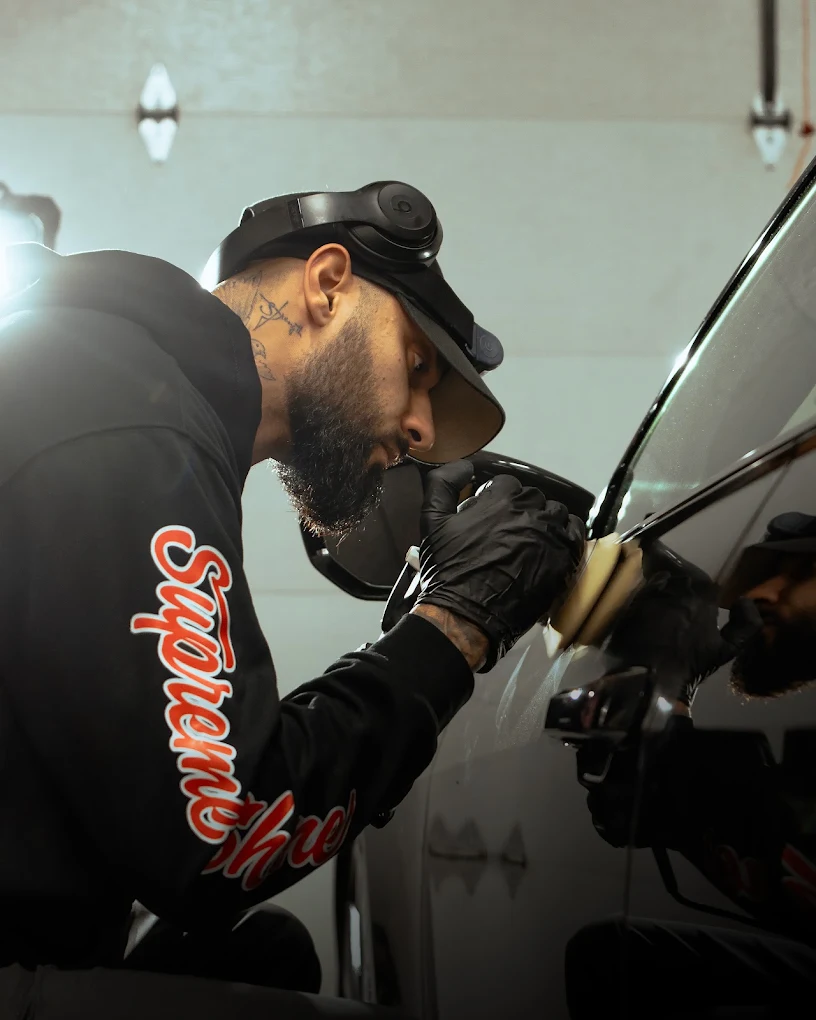 Detailer performing paint correction
